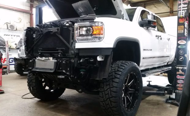 While GMC Denali HD lifted with Fuel Wheels with grille off