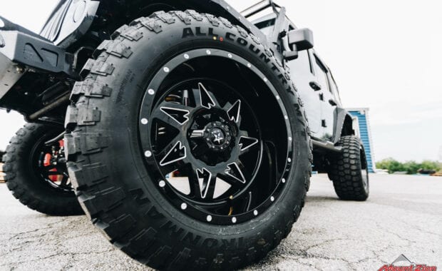 black milled wheels and tires on black jeep