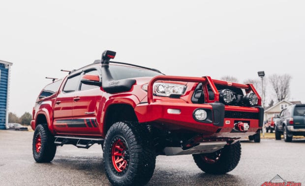17 Tacoma fox 2.5 coilover suspension on 17x9 6x5.5 106.1 Candy Red Covert Fuel MHT -12mm and Nitto Ridge Grappler 33x12.50R17 tires with snorkel and offroad bumper front passenger side view