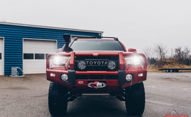17 Tacoma fox 2.5 coilover suspension on 17x9 6x5.5 106.1 Candy Red Covert Fuel MHT -12mm and Nitto Ridge Grappler 33x12.50R17 tires with snorkel and offroad bumper front grille view