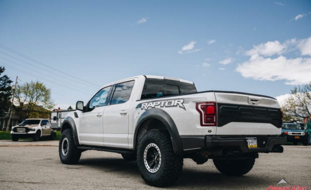 White 2018 Ford Raptor with 37x12.50R17 General Grabber X3 M/T rear driver side tailgate view