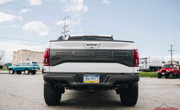 White 2018 Ford Raptor with 37x12.50R17 General Grabber X3 M/T rear tailgate view
