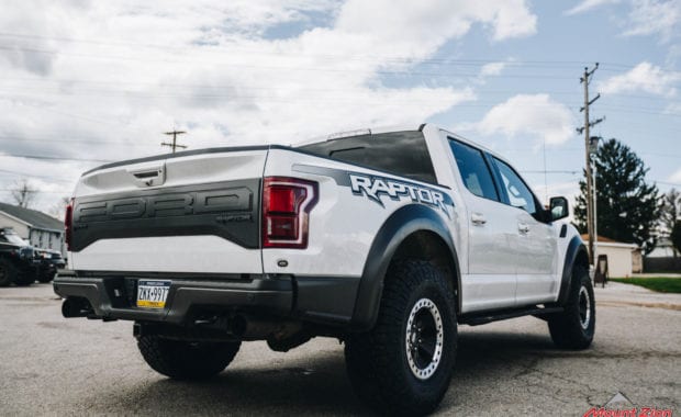 White 2018 Ford Raptor with 37x12.50R17 General Grabber X3 M/T rear passenger side tailgate view