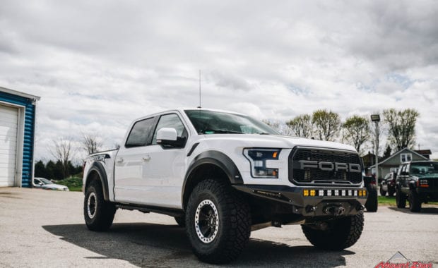 White 2018 Ford Raptor with 37x12.50R17 General Grabber X3 M/T front passenger side grille view