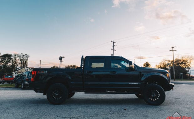 Black 2019 F250 with black wheels passenger side view
