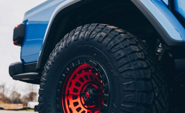 Red Fuel wheel on blue jeep rear passenger side