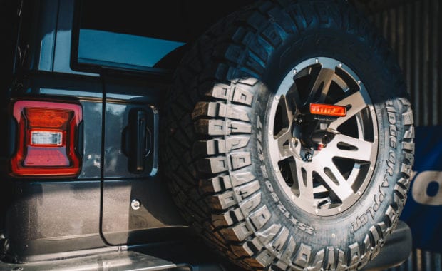 5th wheel tire carrier on grey jeep