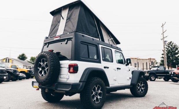White Jeep Wrangler with Ursa Minor J30 Camper Top and ARB Awning rear passenger side tailgate view