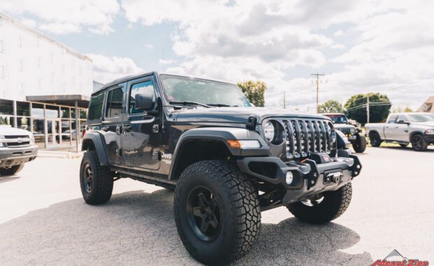 2019 Jeep Wrangler with AEV N0724100AA 2.5in suspension on AEV 20402034AA Pintler Wheel In Matte Black and 35X12.50R17 Falken Wildpeak AT3W front passenger grille view