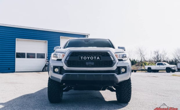 2019 Tacoma TRD Pro with Bilstein 5100 leveling kit on Method 701 16x8.5 wheels and Goodyear LT265/75R16 Tires front grille view