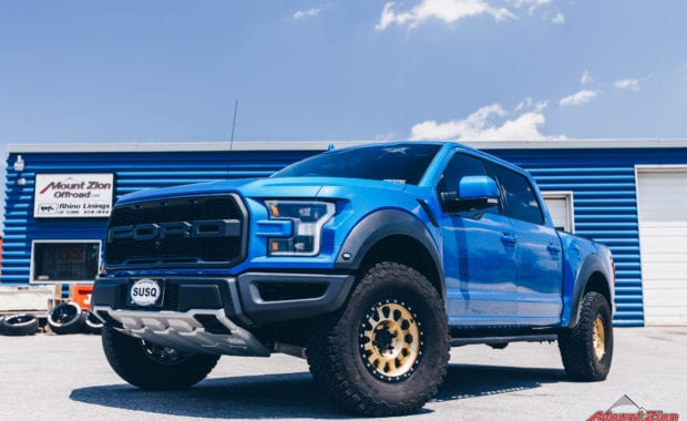 Blue 2020 Ford Raptor with Gold Method 315 17x8.5 +0 mm Wheels front driver side grille view