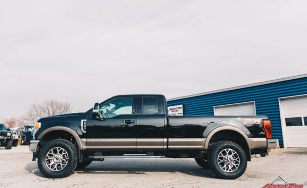 2020 Black F-350 with readylift 2.5 leveling kit and geolander tires driver side view