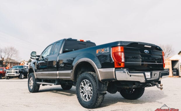 2020 Black F-350 with readylift 2.5 leveling kit and geolander tires rear driver side tailgate view