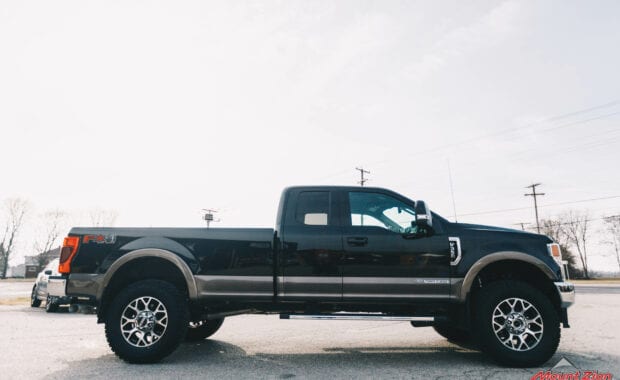 2020 Black F-350 with readylift 2.5 leveling kit and geolander tires passenger side view