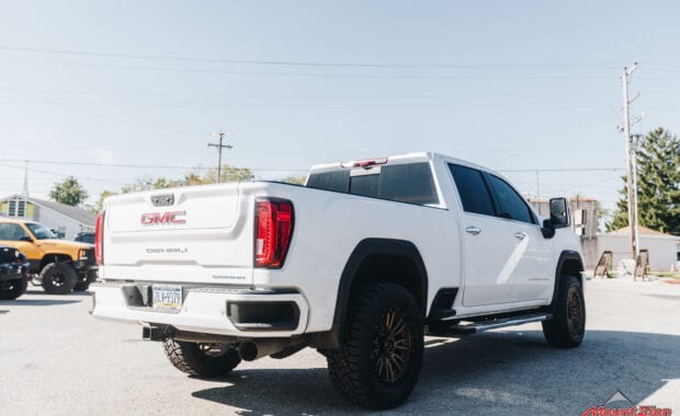 GMC Sierra 2500 with COGNITO 3” lift on Fuel REBEL 8 BRONZE 20x9 +01 Wheels andToyo Open Country R/T 35x12.50R20 Tires rear passenger side tailgate view