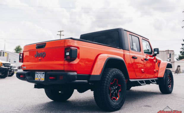 Orange Gladiator Rubicon RC 3/4 Coil Spacer on Falken AT3W 35x12.50R17 and Painted Wheels Clear Candy Orange rear passenger side tailgate view