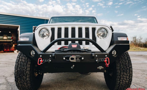 white jeep wrangler with offroad bumper and warn winch