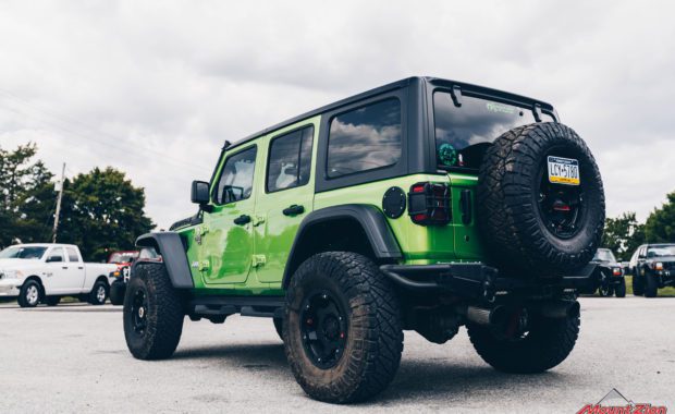 2020 Green Jeep Wrangler with 3.5 Metal Cloak lift kit on Teraflex Nomad Wheels 17x8.5 Deluxe Metallic Black and Nitto Ridge Grappler 37x12.50R17 Tires rear driver side tailgate view