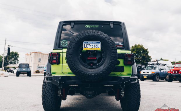 2020 Green Jeep Wrangler with 3.5 Metal Cloak lift kit on Teraflex Nomad Wheels 17x8.5 Deluxe Metallic Black and Nitto Ridge Grappler 37x12.50R17 Tires rear tailgate with 5th wheel tire carrier view