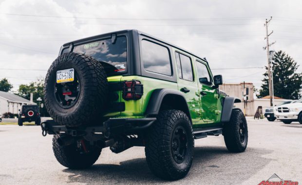 2020 Green Jeep Wrangler with 3.5 Metal Cloak lift kit on Teraflex Nomad Wheels 17x8.5 Deluxe Metallic Black and Nitto Ridge Grappler 37x12.50R17 Tires rear passenger side tailgate view