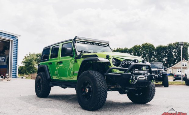 2020 Green Jeep Wrangler with 3.5 Metal Cloak lift kit on Teraflex Nomad Wheels 17x8.5 Deluxe Metallic Black and Nitto Ridge Grappler 37x12.50R17 Tires front passenger side grille view