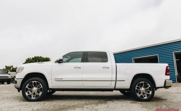 White Ram 1500 with Rough Country 2IN lift on LT285/50R22/10 121/118R NITTO TERRA GRAPPLER G2 tires driver side view