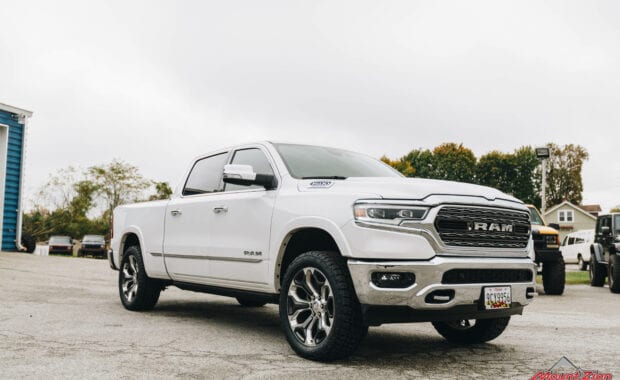 White Ram 1500 with Rough Country 2IN lift on LT285/50R22/10 121/118R NITTO TERRA GRAPPLER G2 tires front passenger side grille view