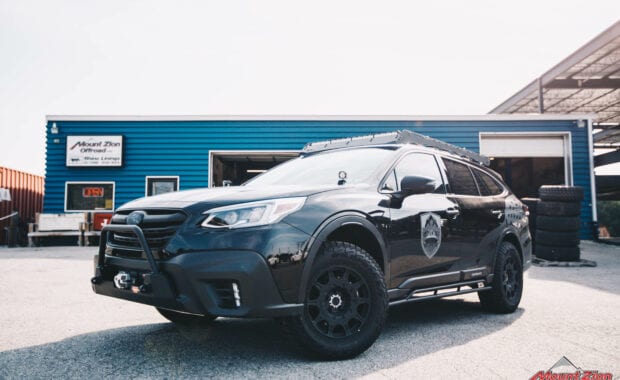 2021 Subaru Outback Touring XT with FLATOUT SUSPENSION on Method 502 Rally Matte Black 17x8 and 245/65R17XL 111T FAL WILDPEAK A/T3W RBL front driver side grille view
